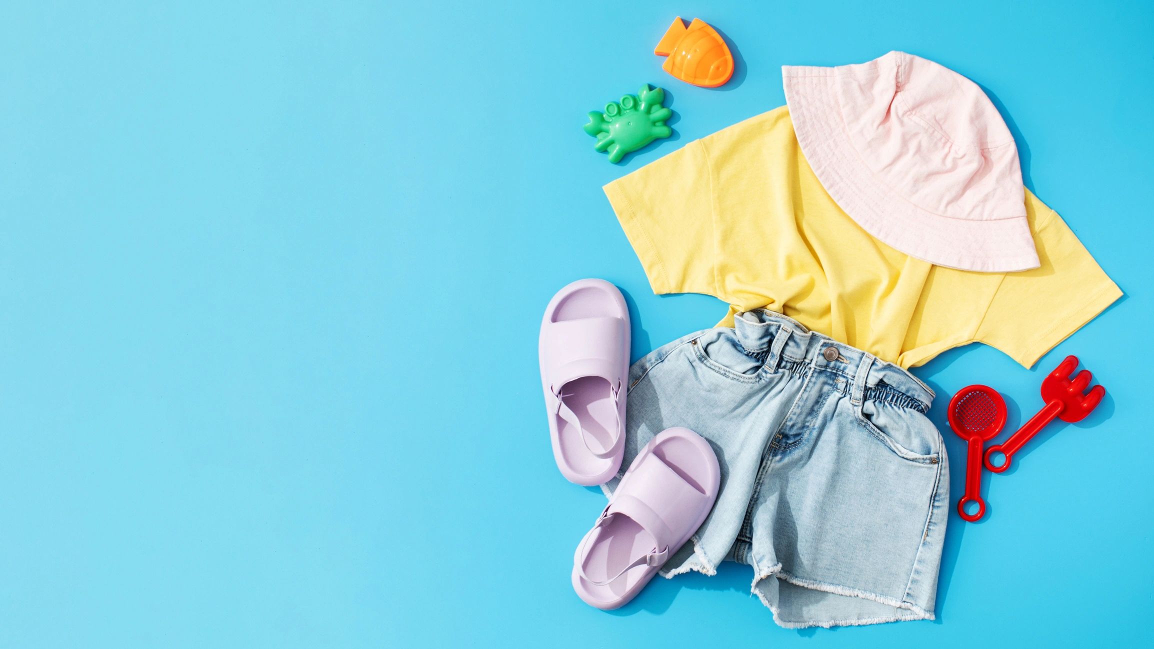 Children's summer clothing and beach accessories flat lay