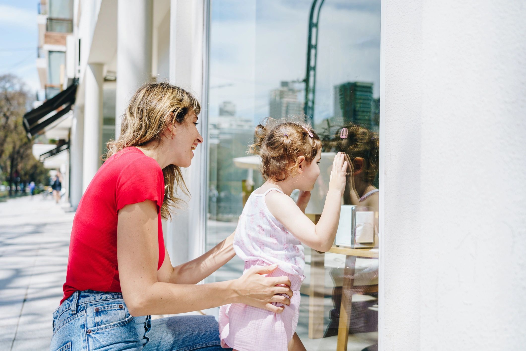 Mother and daughter looking at a store window